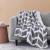 Ventimi electric blanket grey folded on a sofa for cold living room comfort