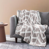 Ventimi beige electric blanket throw on sofa for cozy warmth.