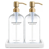 Vine Creations glass soap dispenser set with brushed brass pumps on a stylish counter.