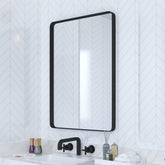 VocalStar black bathroom mirror with 18x26-inch rounded frame over a vanity.