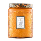 Voluspa Baltic Amber Candle Jar glowing warmly, ideal for cozy living spaces.