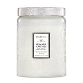 Voluspa Mokara Orchid 18 oz candle in a decorative jar for floral ambiance.