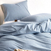 Wake In Cloud striped cotton duvet cover in denim blue with corner ties and zipper.