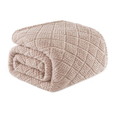 Whale Flotilla fuzzy fleece blanket on bed in camel color for warmth.