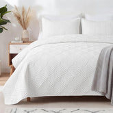 Whale Flotilla quilt with embossed pattern adding chic comfort to the bedroom