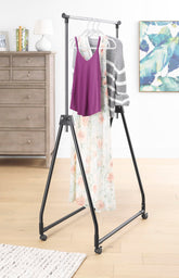 Whitmor folding garment rack with rolling hanger offering portable wardrobe space.