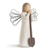 Willow Tree angel garden figurine in cream dress stands as a garden decor piece