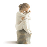 Willow Tree Guardian figure in cream dress seated on gray rock holding a newborn