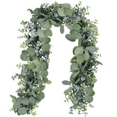 Winlyn 5.9' eucalyptus garland draped over an arch for ceremony backdrop.