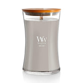 WoodWick Wood Smoke Hourglass Candle glowing warmly for cozy ambiance