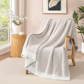 WRENSONGE throw blanket on couch in taupe, providing cozy warmth for evenings