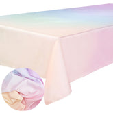 xo, Fetti pastel-gradient tablecloth fully spread on a long dining table for a vibrant indoor celebration