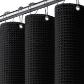 XOGUIBO waffle-weave shower curtain with black texture provides privacy and style.