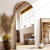 XRAMFY 56x21 floor mirror with an arched frame reflecting room lighting