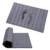 Zmnklry foldable stone bath mat rolled for compact storage.