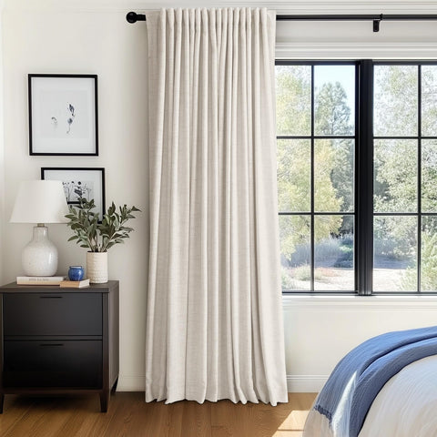 Window covered by 100% Blackout Shield curtains showing generous 100W x 96L coverage.
