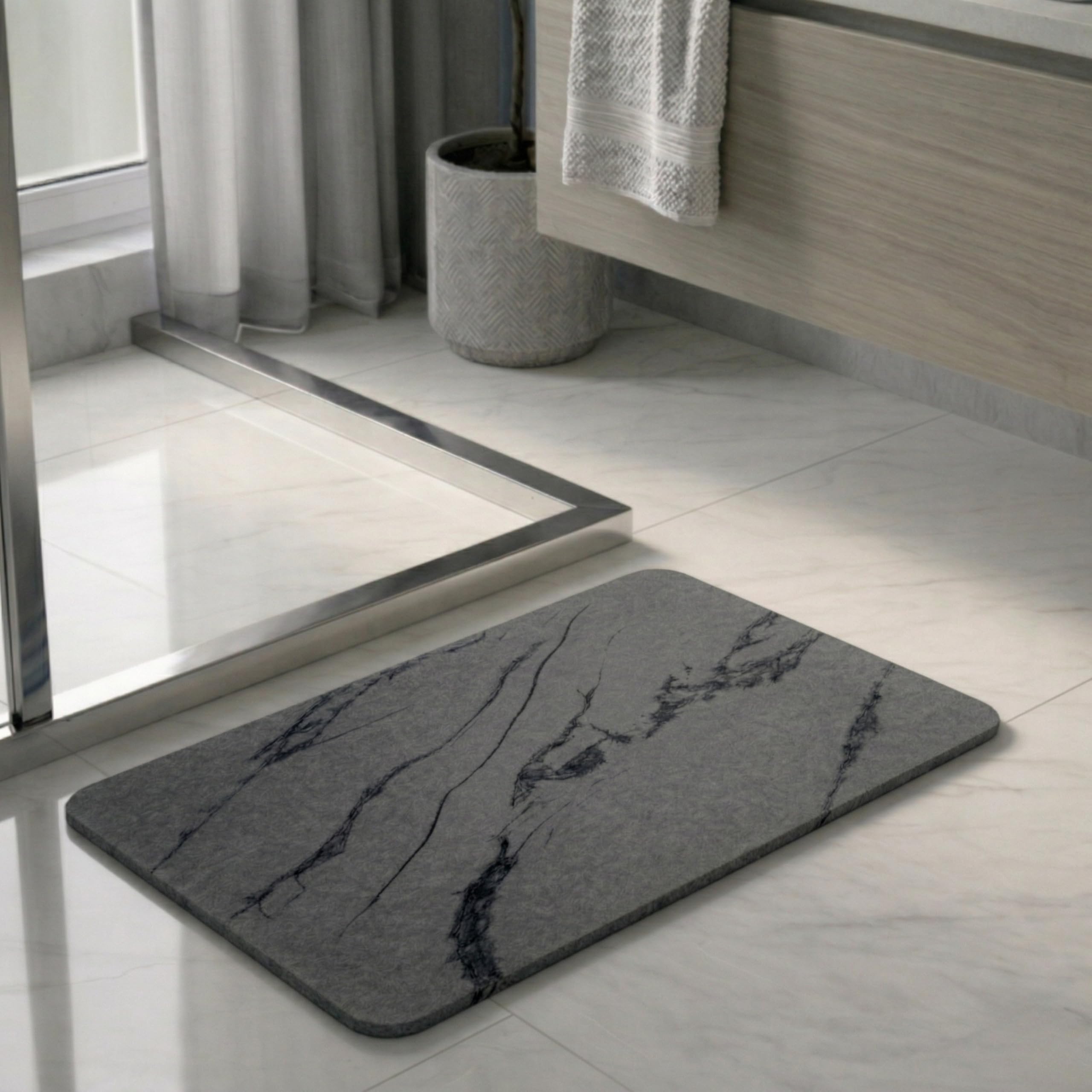 Pebble Nest stone bath mat in charcoal marble; fast-drying surface keeps floors dry.