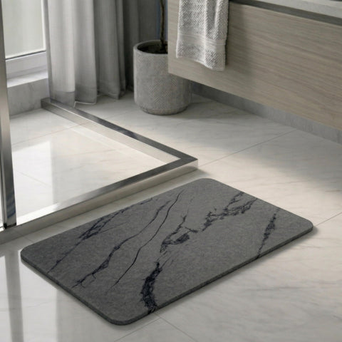 Pebble Nest stone bath mat in charcoal marble; fast-drying surface keeps floors dry.