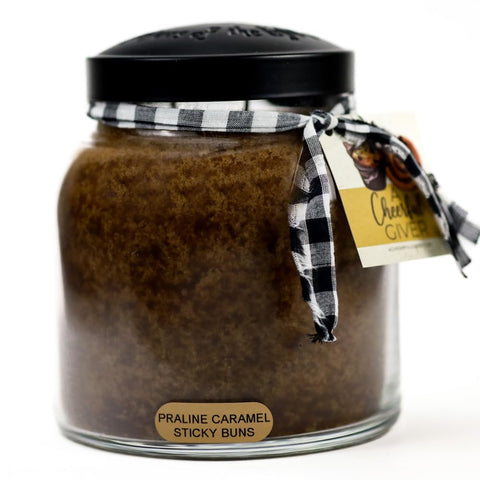 A Cheerful Giver praline caramel sticky buns candle jar creates cozy ambiance.