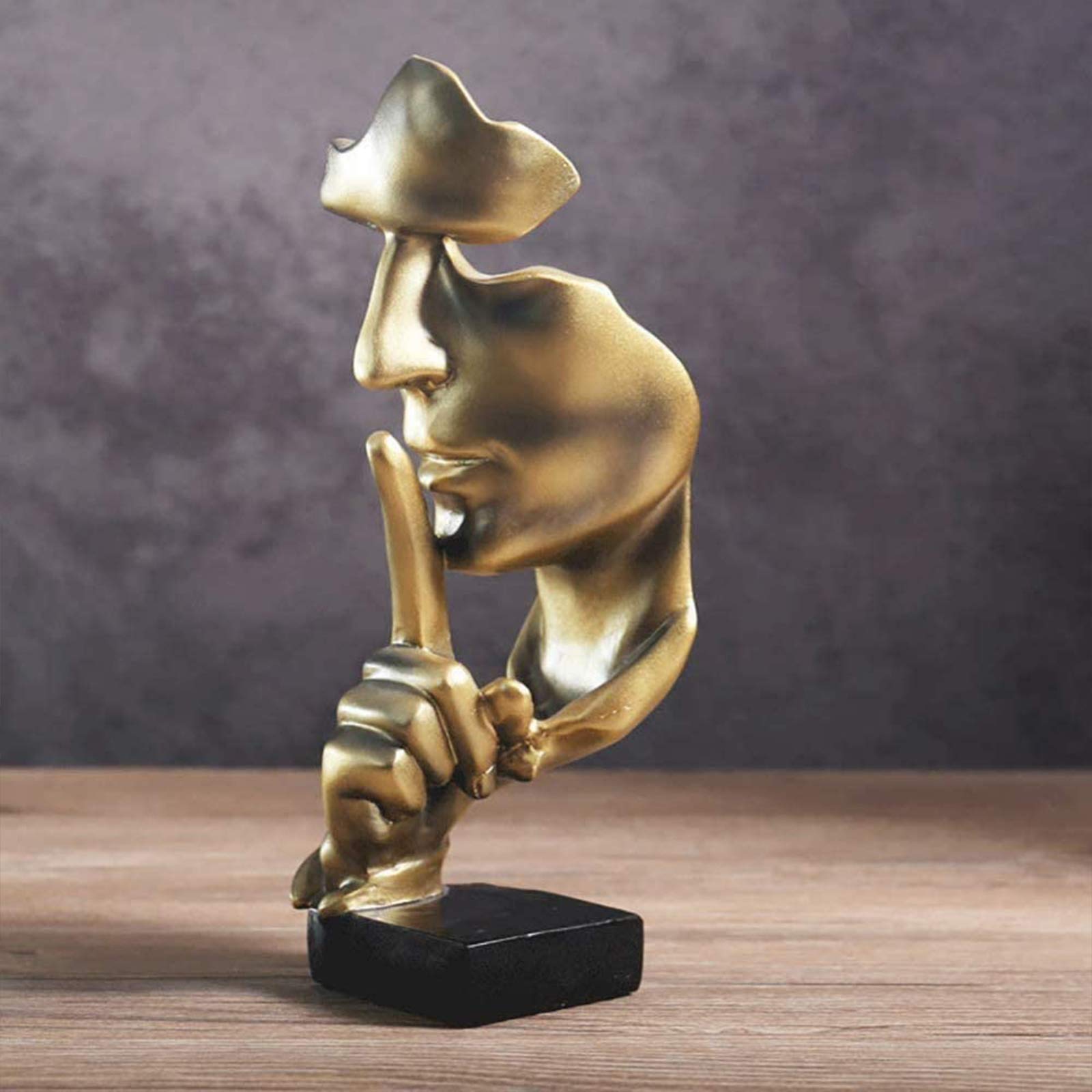 aboxoo Thinker desktop decor in gold enhances a tidy workspace.
