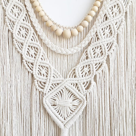 Achart macrame wall art with natural wood rod blends with neutral interiors