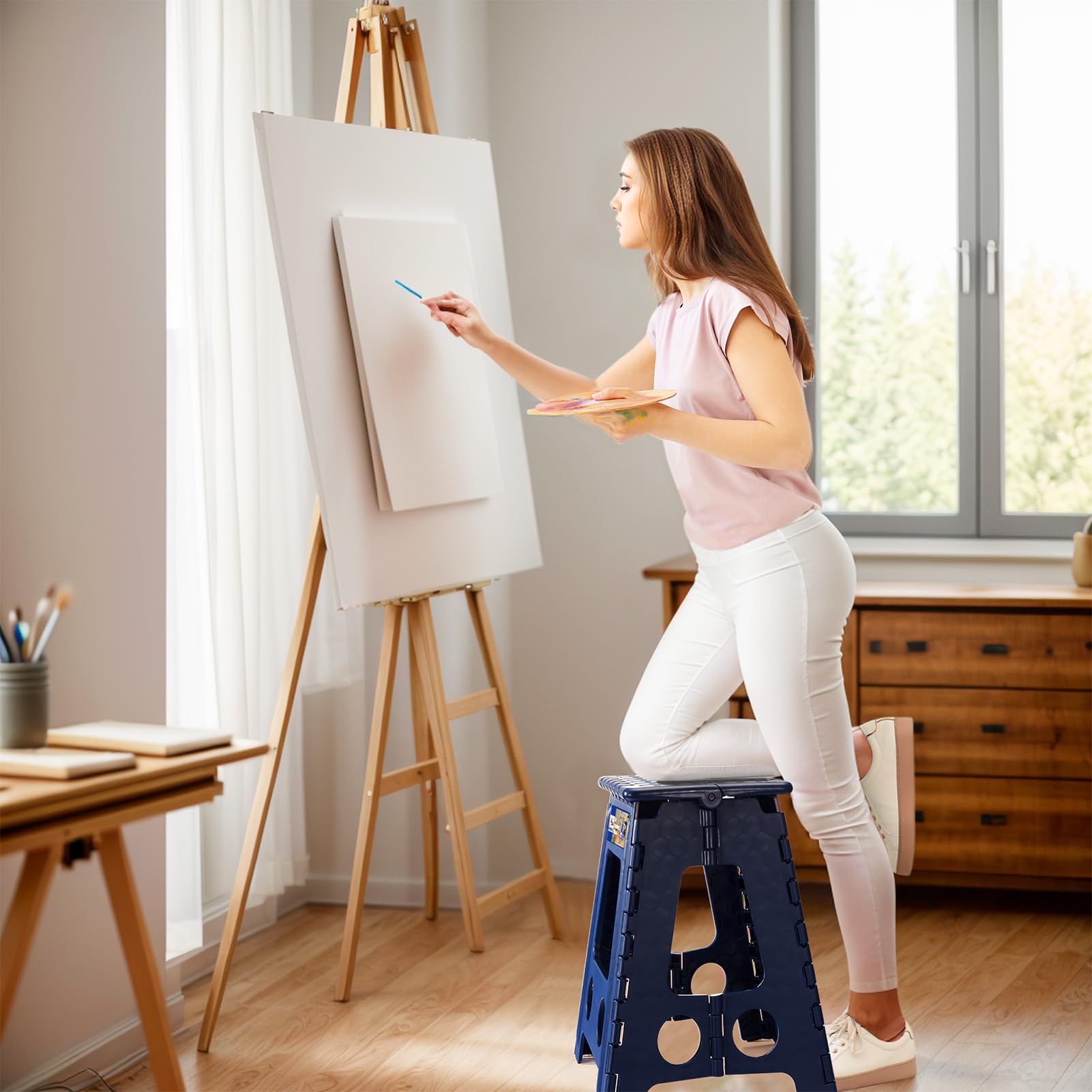 ACKO folding step stool supports living room or office tasks.