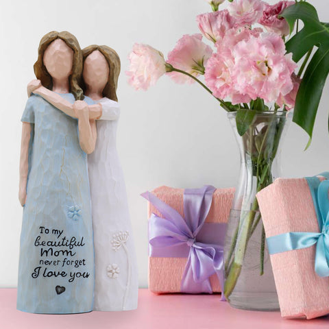 AcowSpt mother-daughter bond figurine detail, close-up shows expressive carving and warmth.