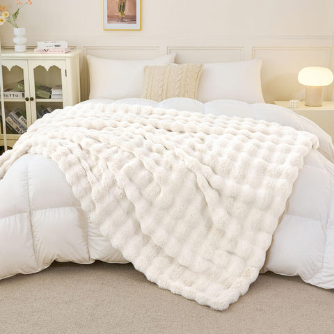 Admitrack 50x60-inch cream white throw on sofa enhances warmth.