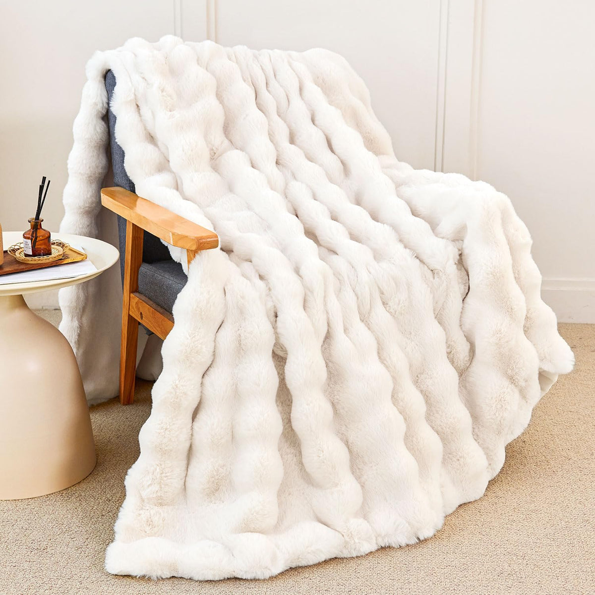 Admitrack faux rabbit fur throw on couch adds luxurious warmth.