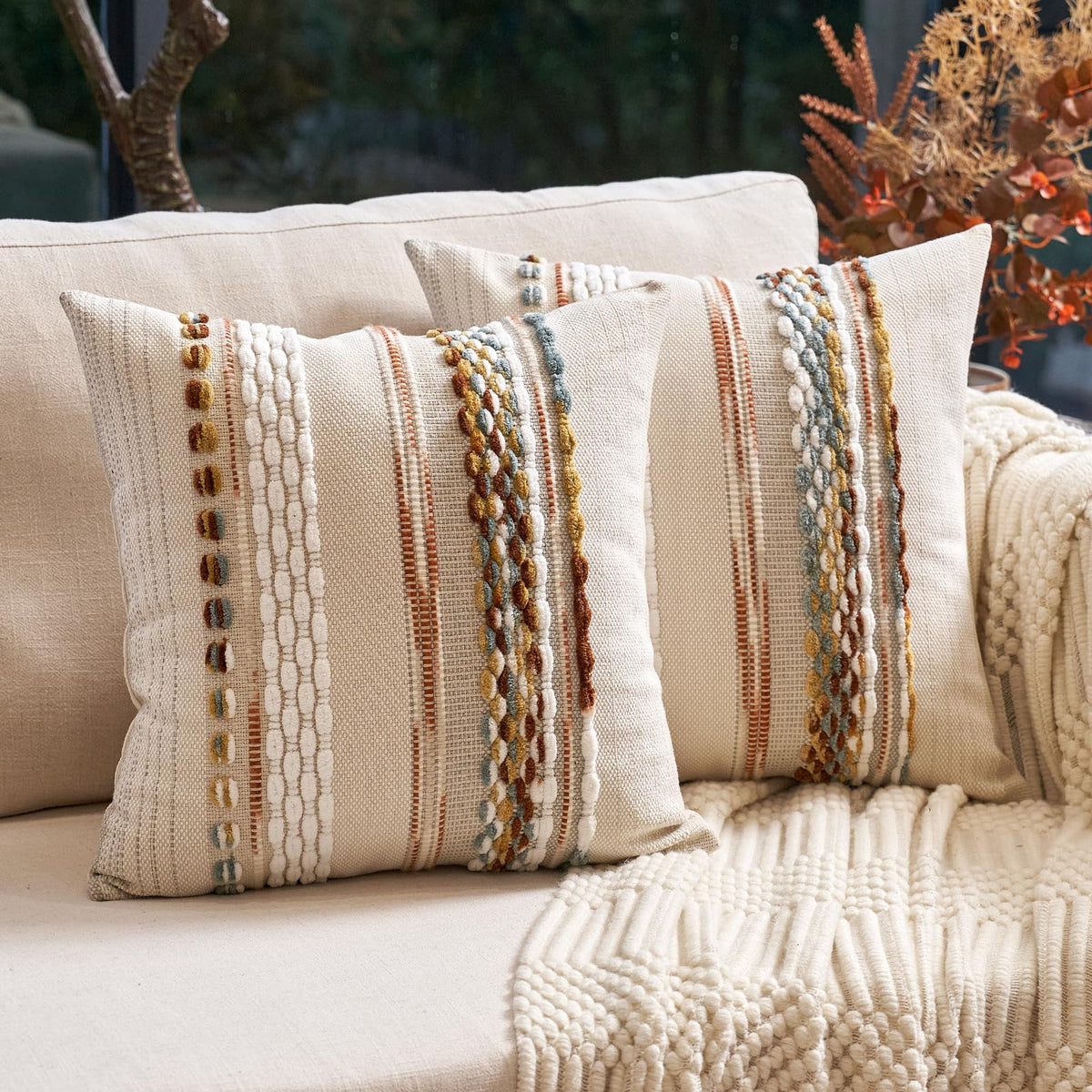Aeckself boho pillow cover orange-white stripe adds cozy texture to sofa.