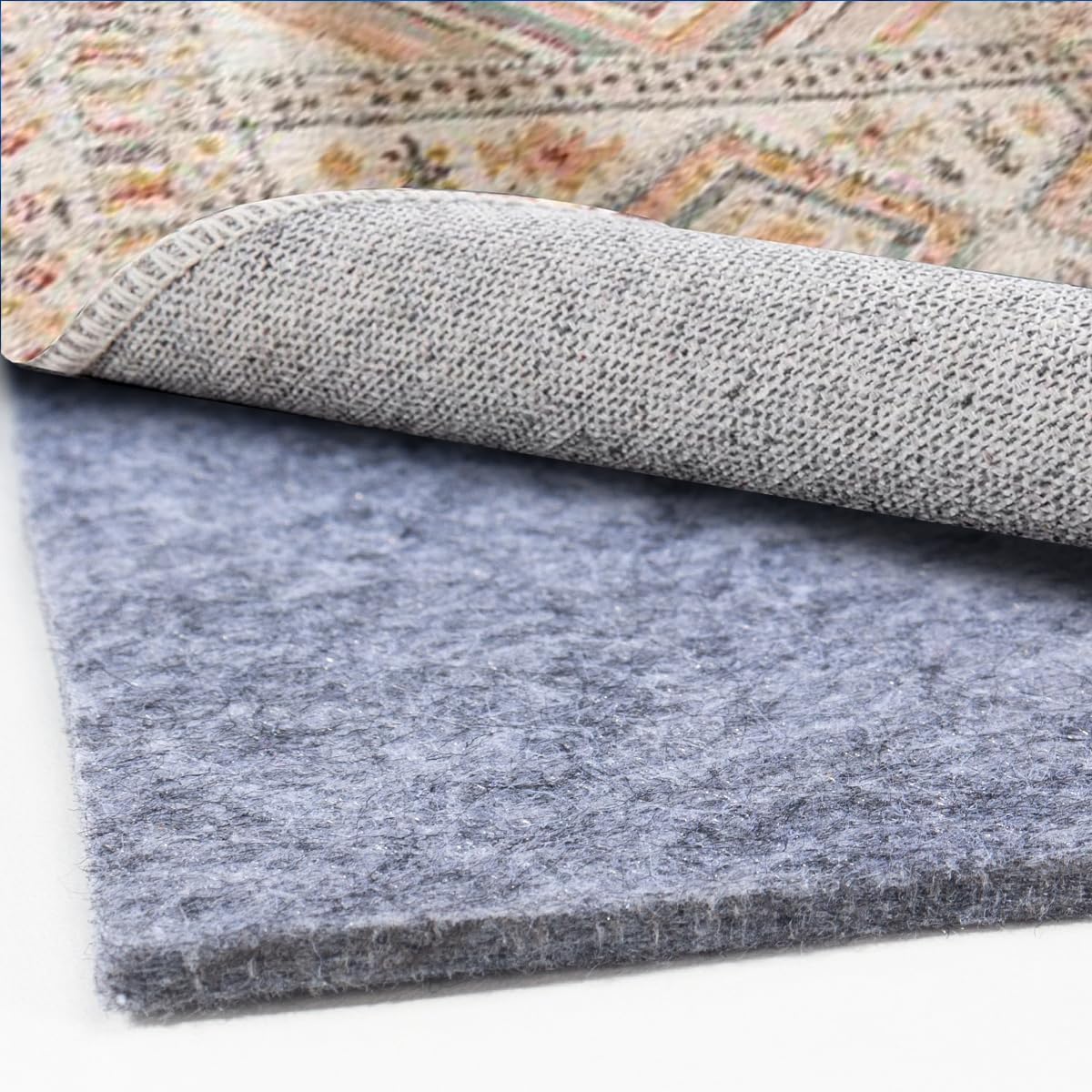 AEHISDHIE extra-large rug pad 8x10 laid under a plush rug for added cushioning.