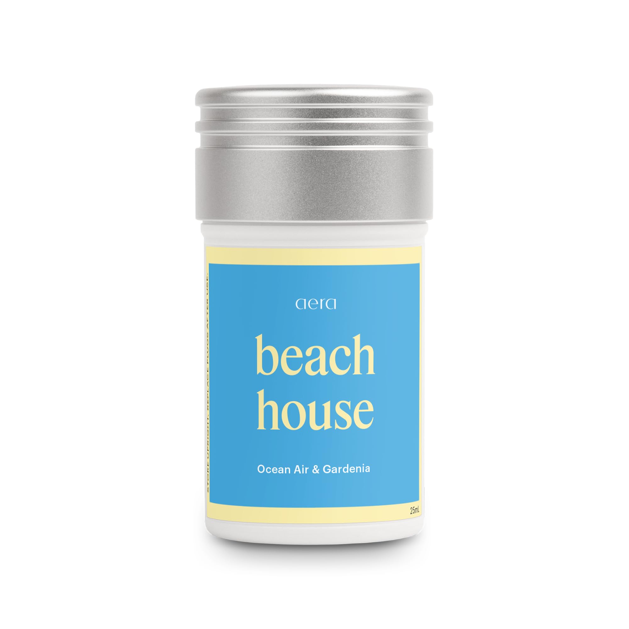 Aera Beach House ocean air bottle releases a fresh coastal scent.