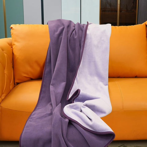Ahinahwap waterproof blanket on a bed in deep purple guards against spills.
