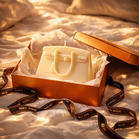 Air WAX handbag candle on a bedside table enhances cozy bedroom decor.