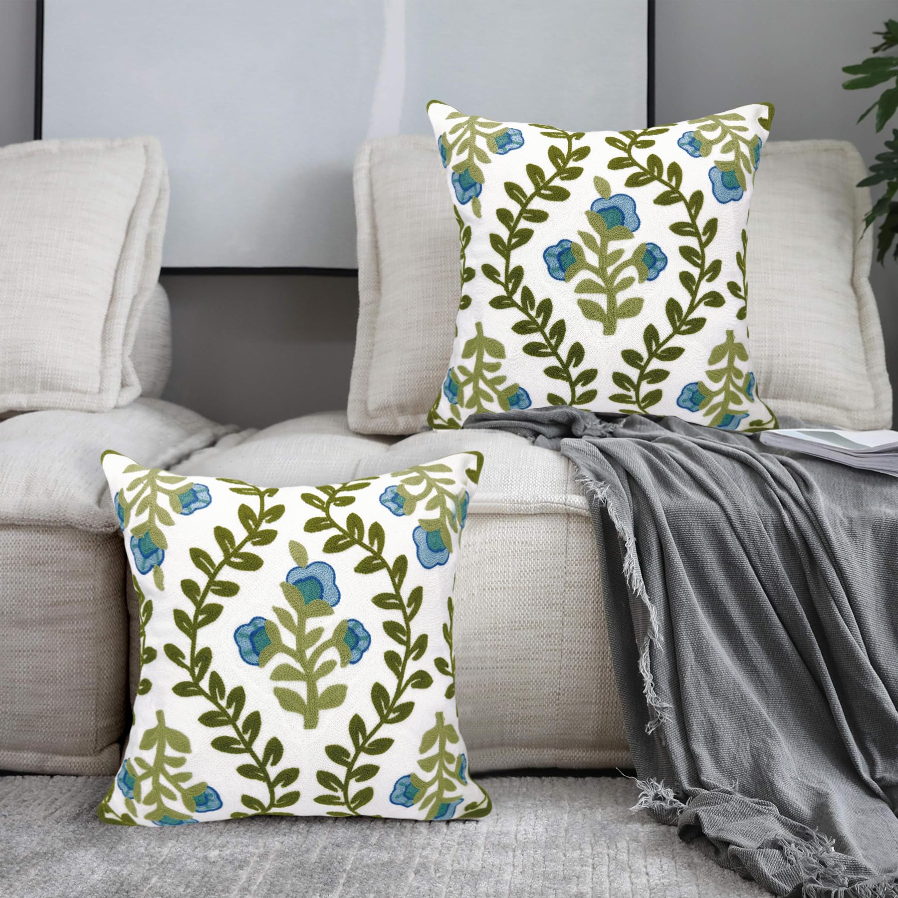 Alysheer embroidery detail closeup highlights vibrant blue flowers and green vines
