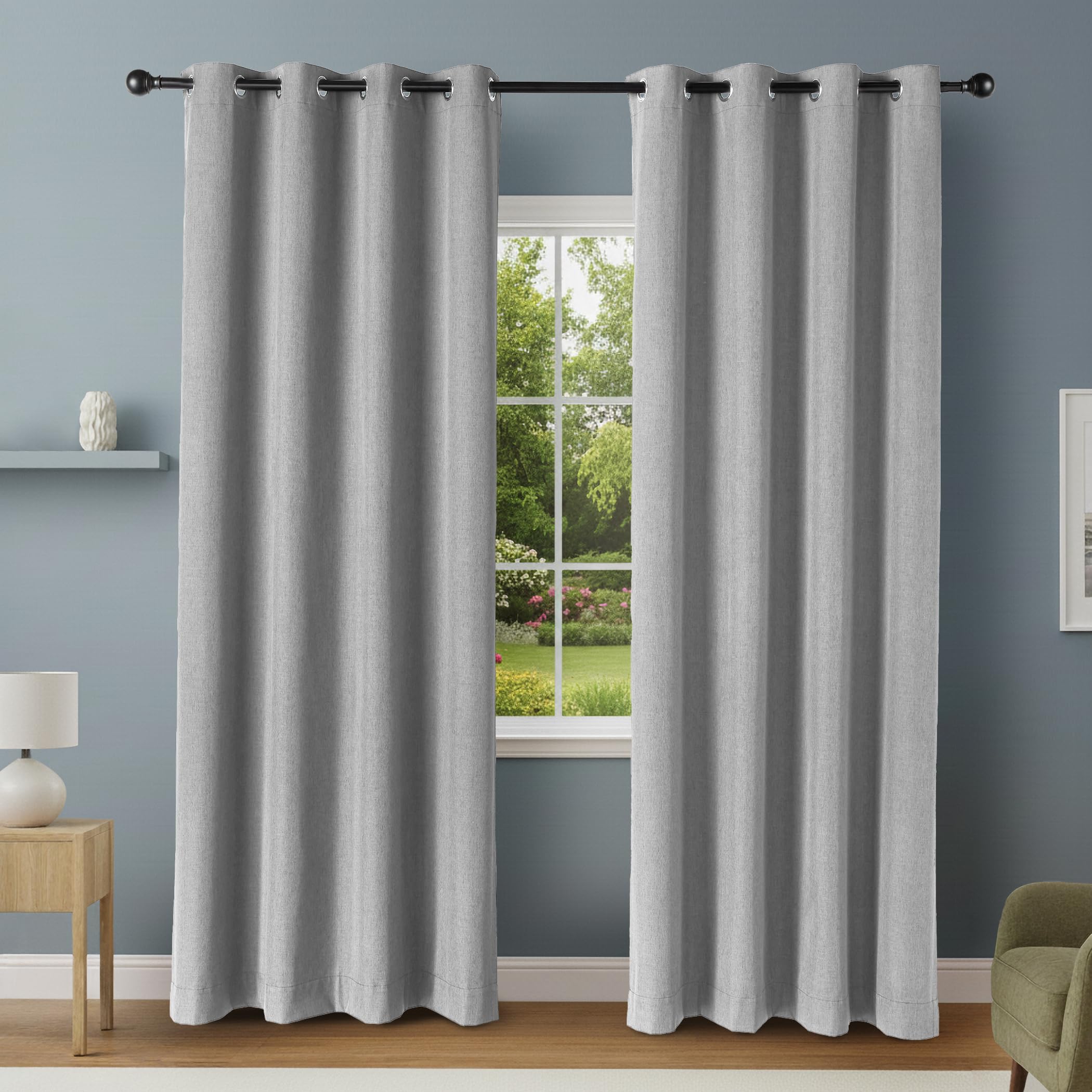 Amazon Basics blackout curtain panels with grommets in dark gray covering large window for privacy