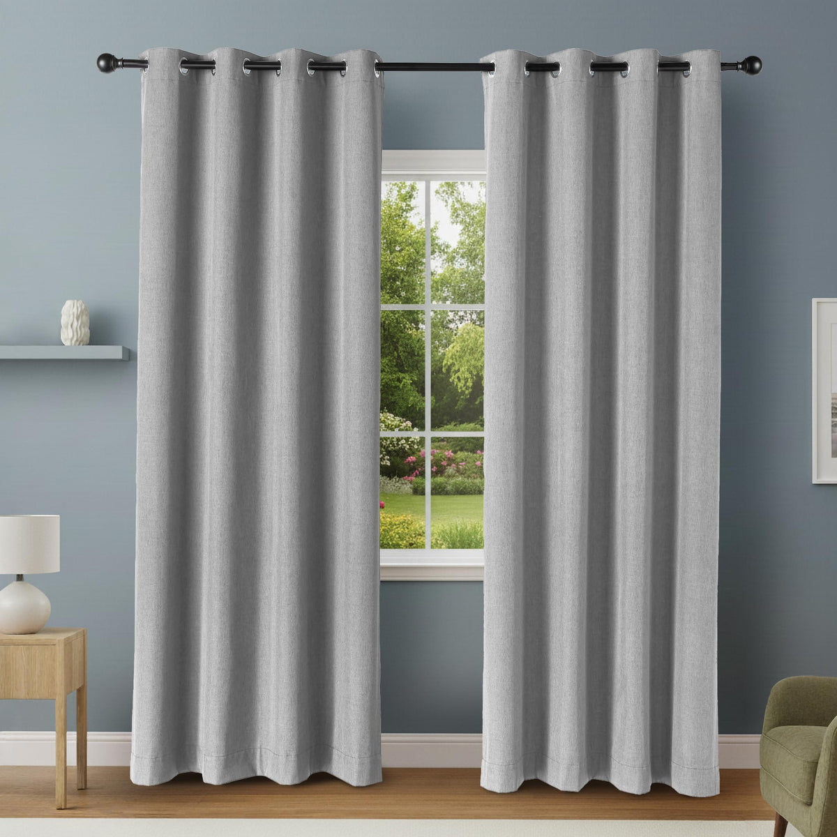 Amazon Basics blackout curtain panels with grommets in dark gray covering large window for privacy