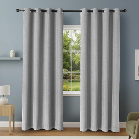 Amazon Basics blackout curtain panels with grommets in dark gray covering large window for privacy