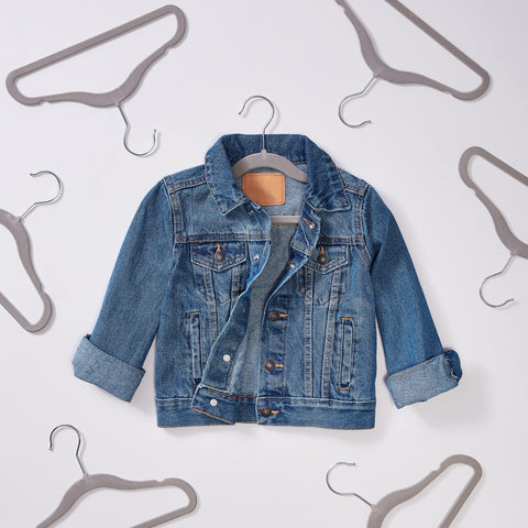 Amazon Basics 11.6-inch durable plastic hangers organize kids' closet space efficiently.