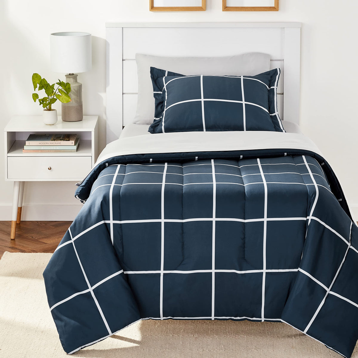 Amazon Basics 5-piece twin bedding set in navy and grey plaid for a coordinated bedroom look.