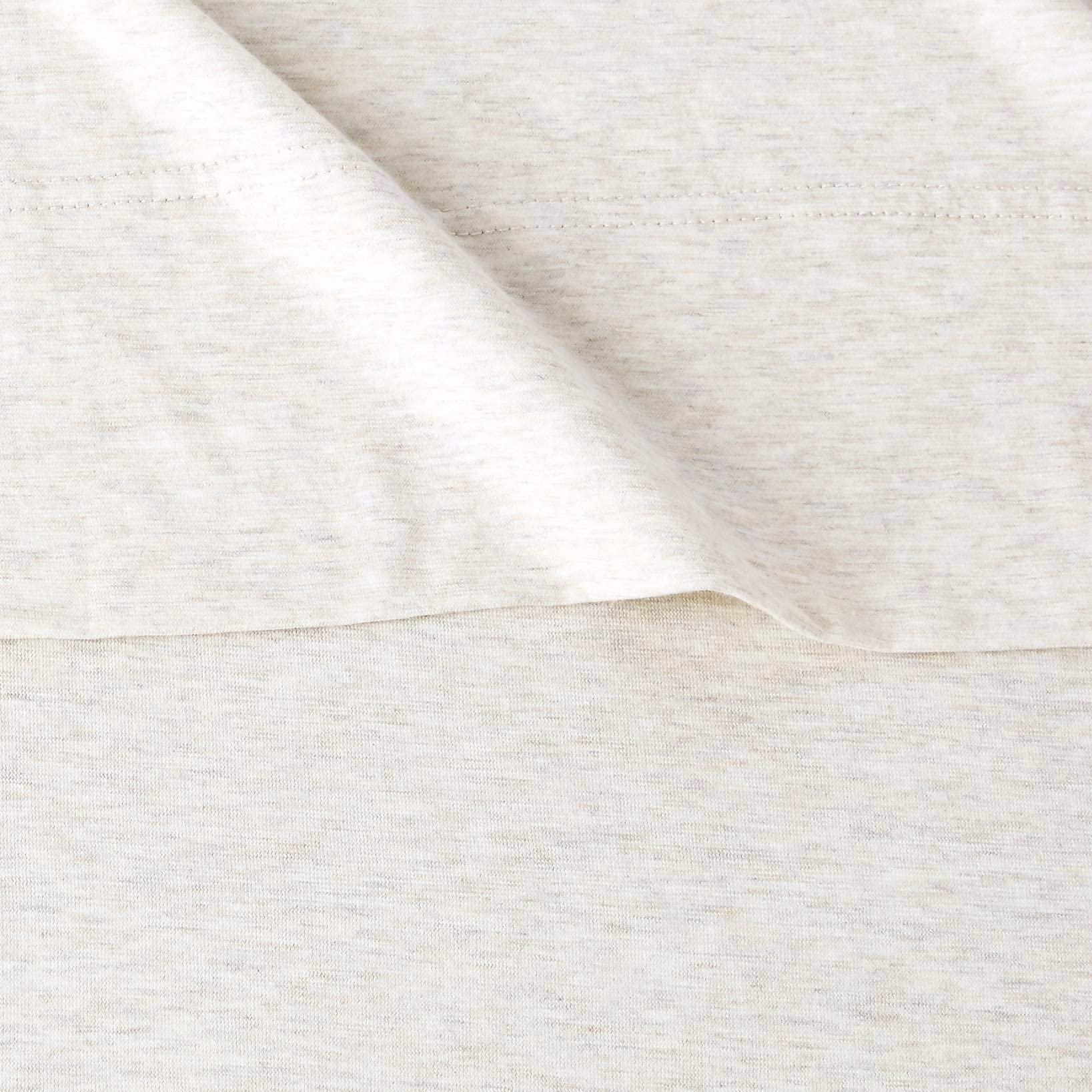 Amazon Basics oatmeal bed sheets in a washer to emphasize easy care.