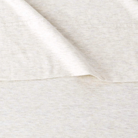 Amazon Basics oatmeal bed sheets in a washer to emphasize easy care.