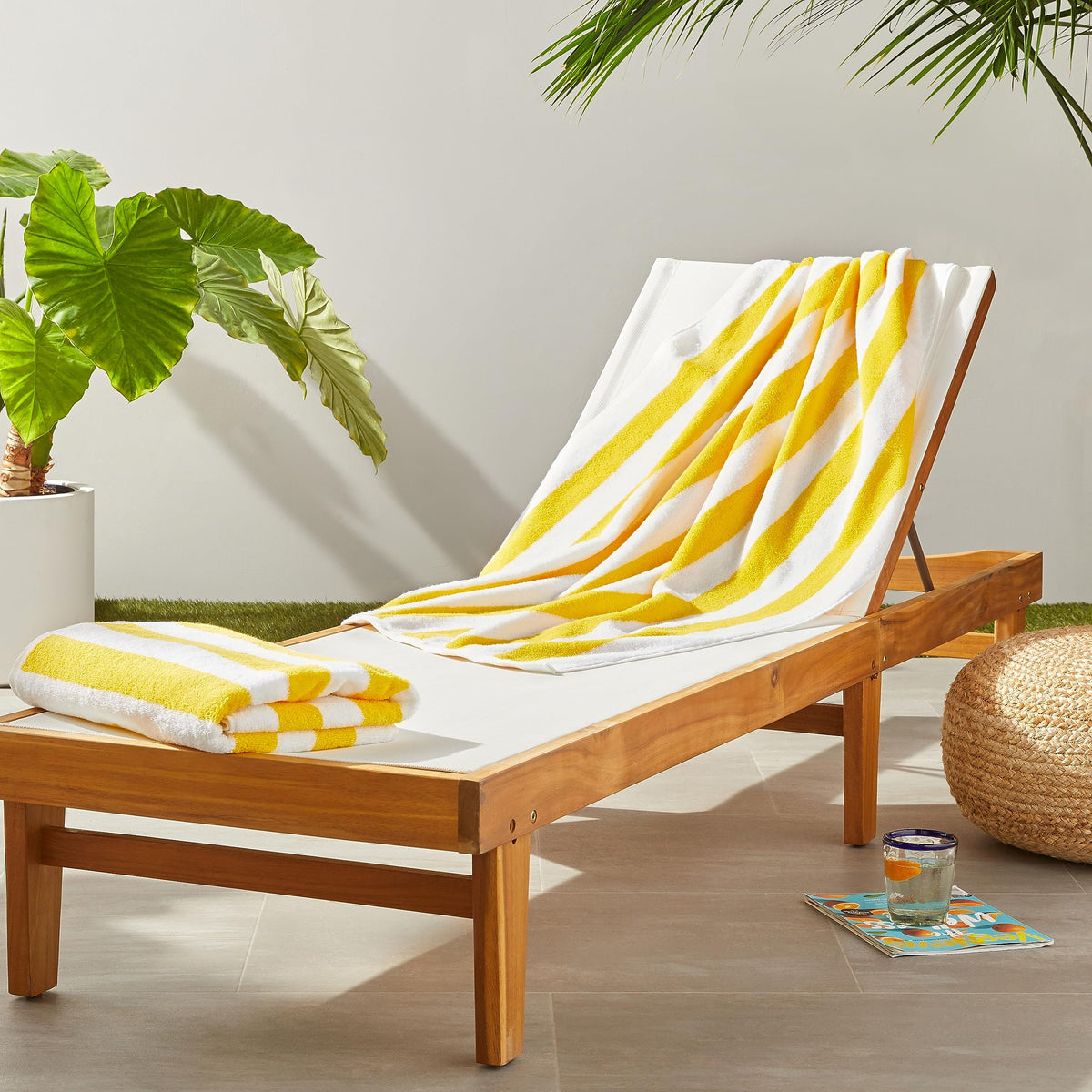 Amazon Basics cabana stripe yellow towel folded, 30x60, plush and absorbent for beach days.