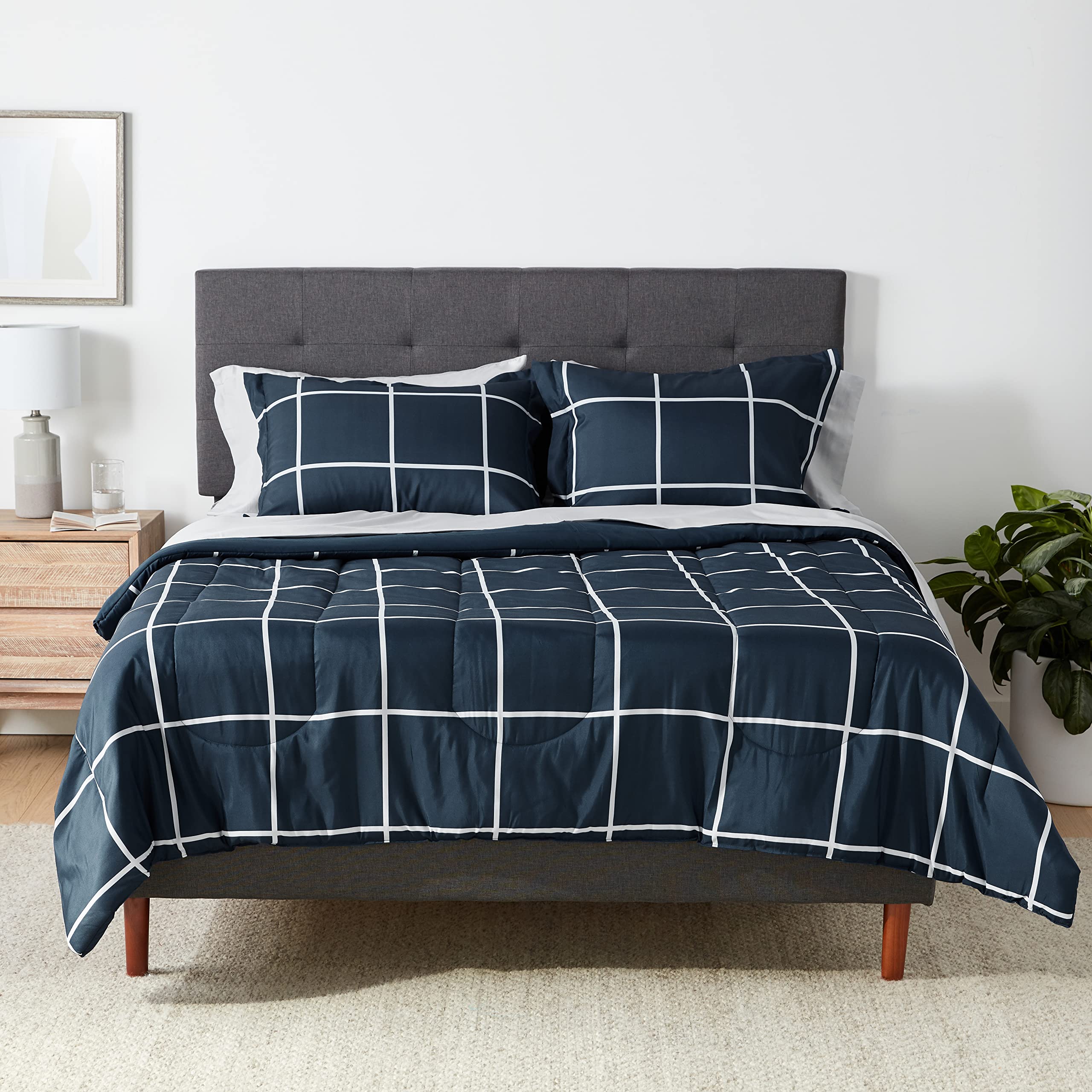Amazon Basics comforter set on bed in navy and grey plaid, soft microfiber