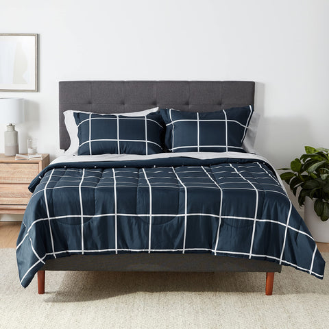 Amazon Basics comforter set on bed in navy and grey plaid, soft microfiber
