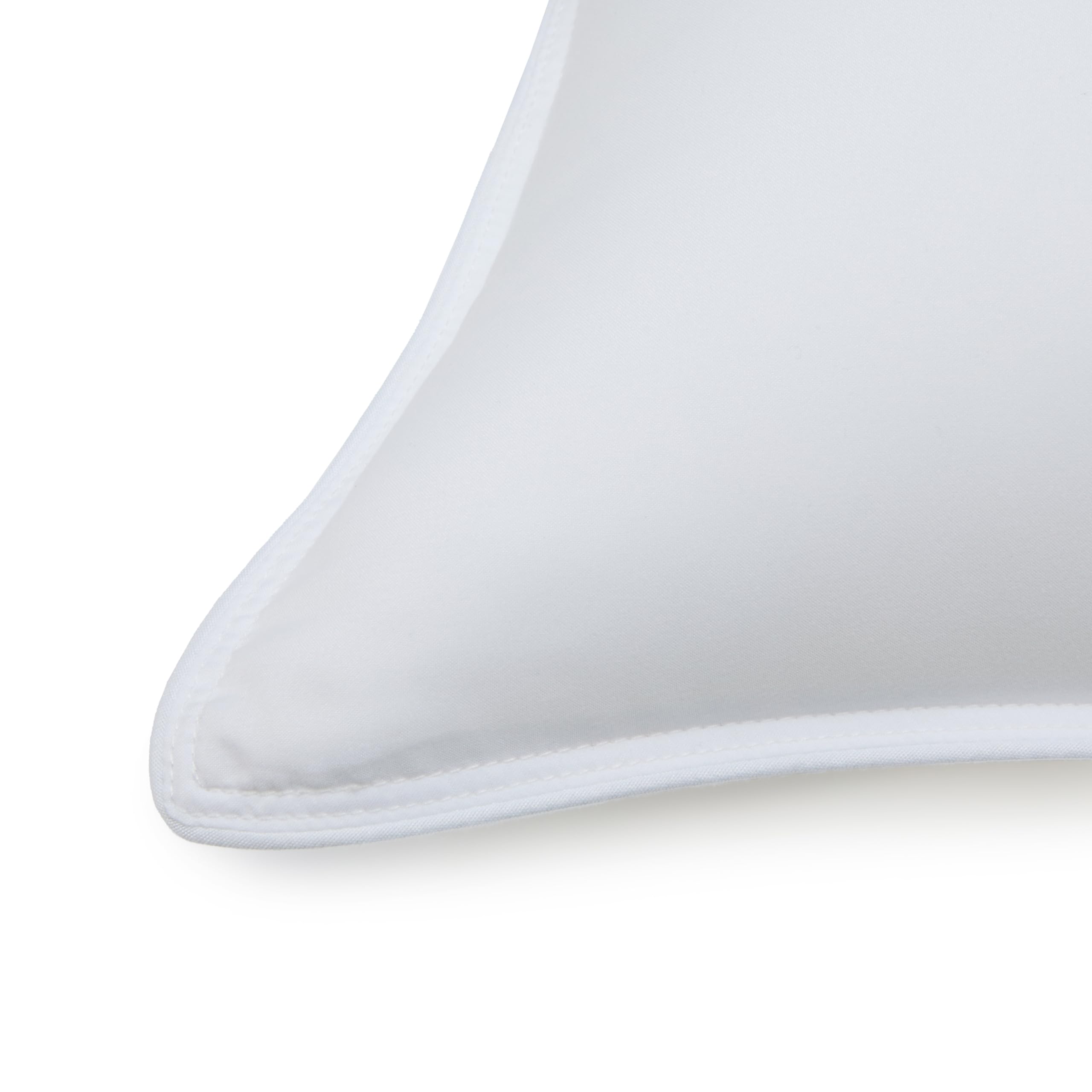 Amazon Basics pillow close-up, microfiber shell and edge piping details.