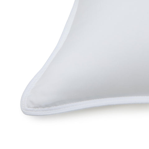 Amazon Basics pillow close-up, microfiber shell and edge piping details.
