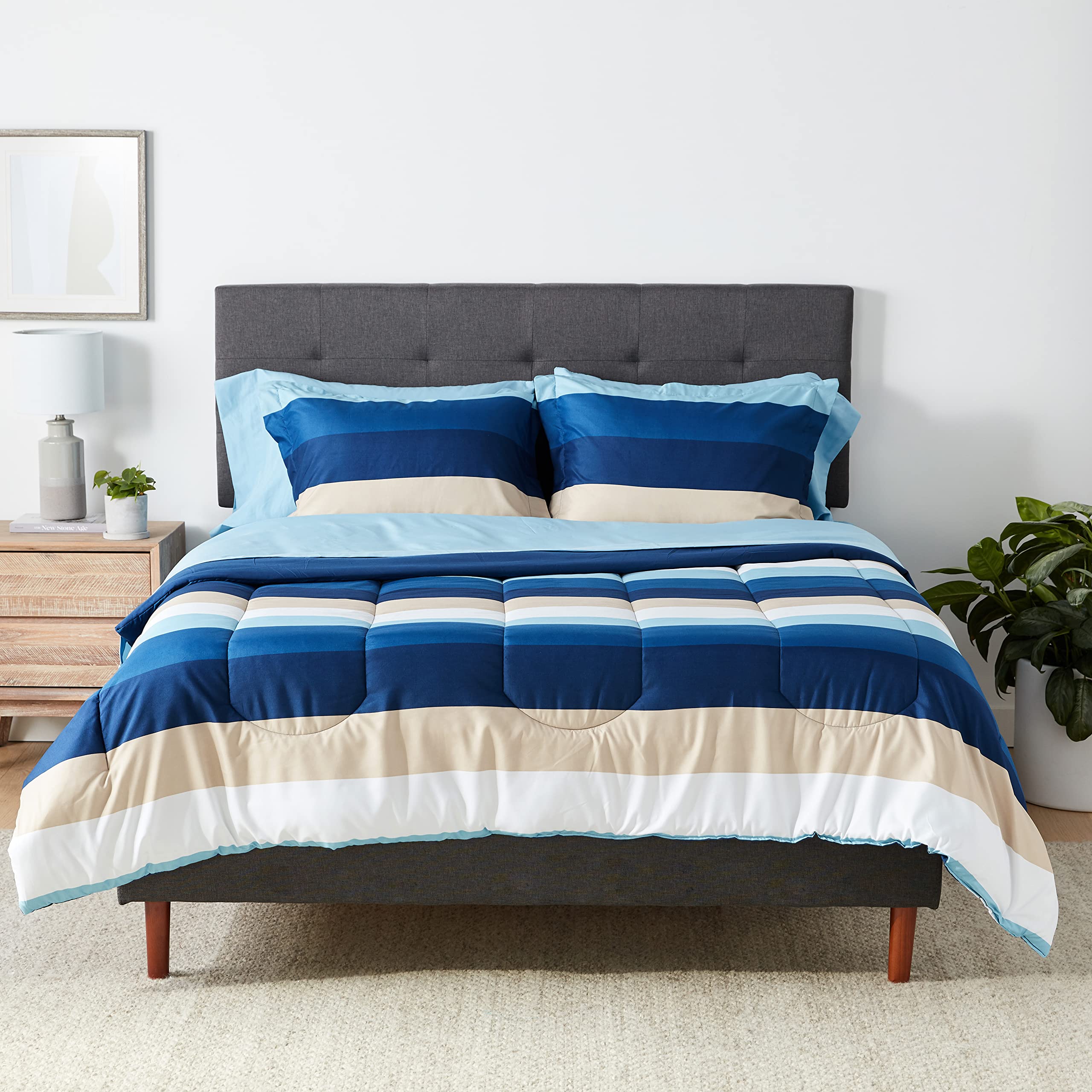Amazon Basics full/queen blue stripe comforter with a soft microfiber weave for cozy nights.
