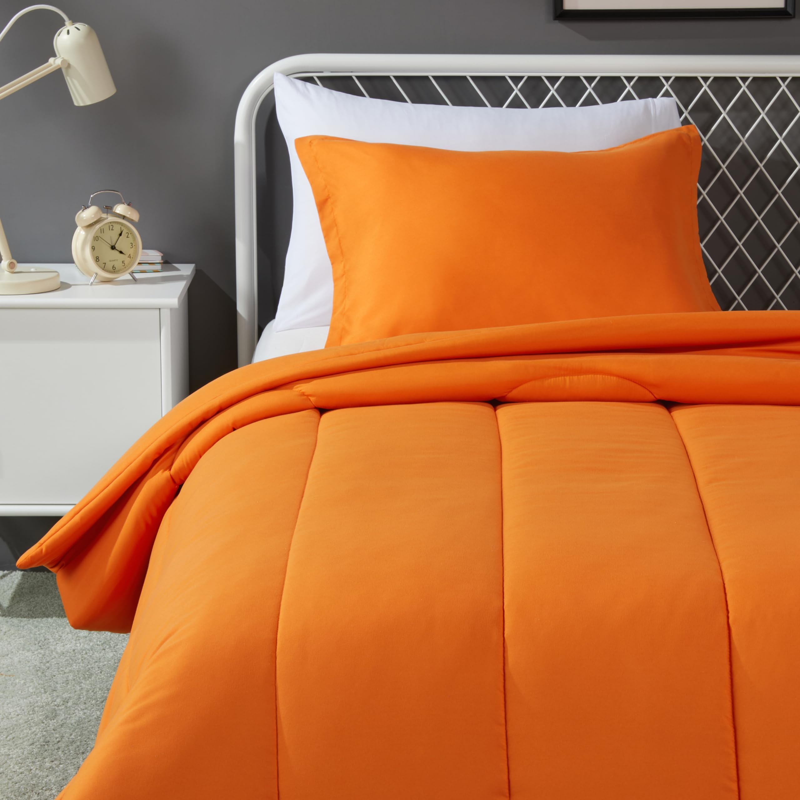 Amazon Basics kids twin comforter in bright orange folded for easy bed updates and soft all-season warmth