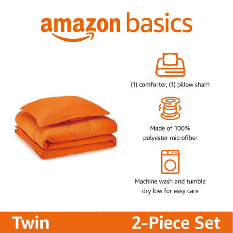 Amazon Basics kids twin comforter in bright orange on bed for quick styling